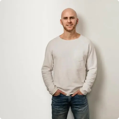 a portrait of Callen McGibbon founder of Rep Health standing in front of a white background.